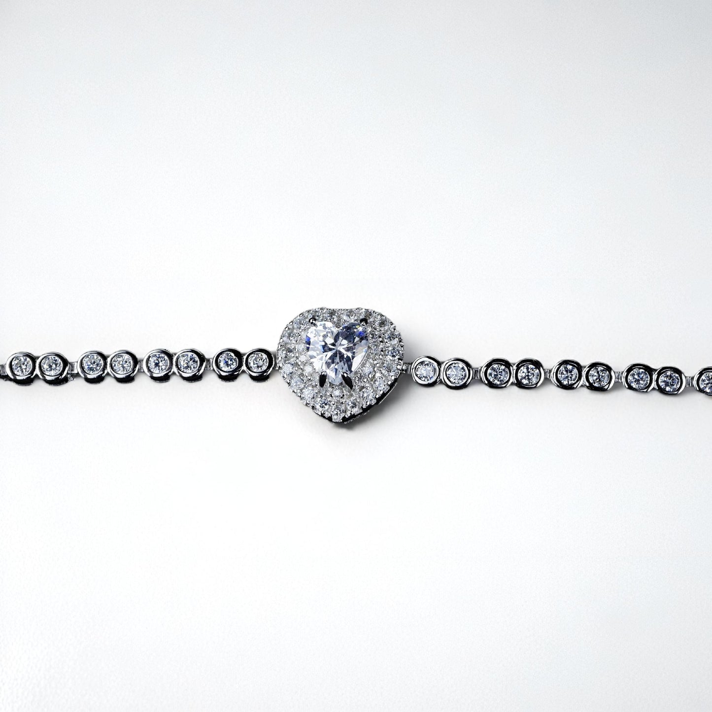 Diamond bracelet with a heart-shaped clasp on a white background