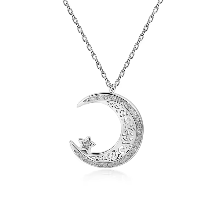 A sterling silver pendant in the shape of a crescent moon with cubic zirconia stones, attached to a silver chain.