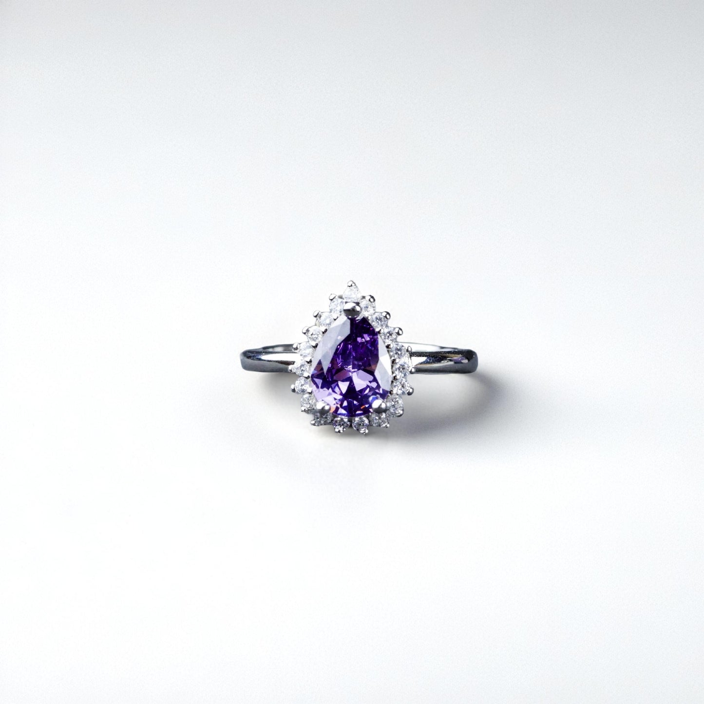 Ring with a purple gemstone on a white background