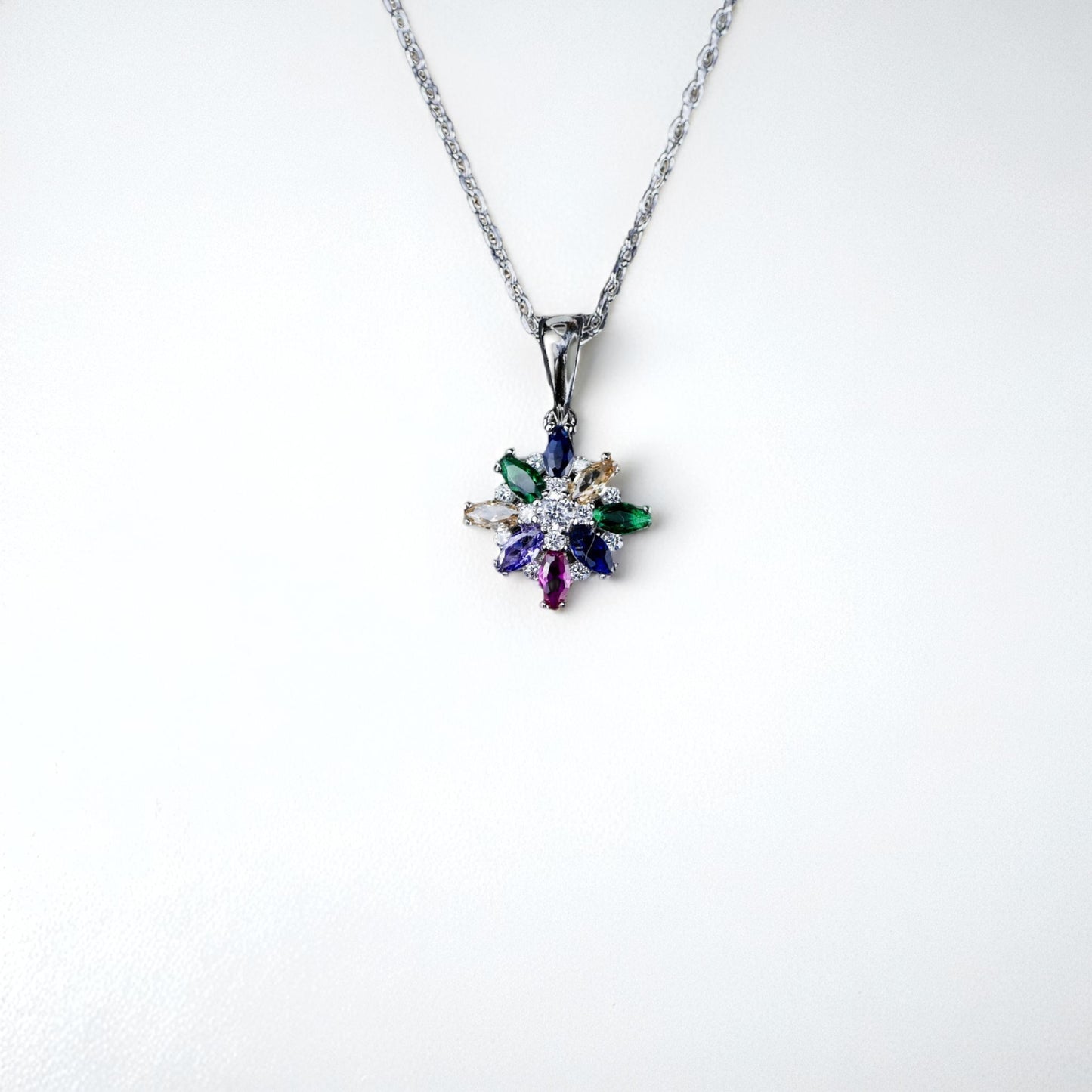Multicolored gemstone pendant on a white background
