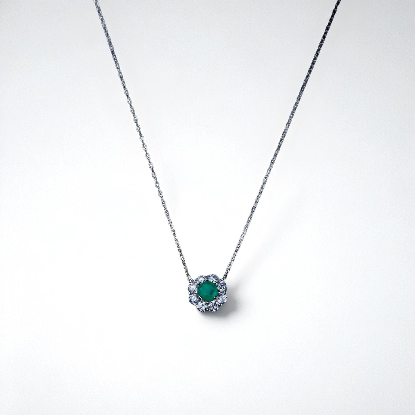 Necklace with a green gemstone pendant on a white background
