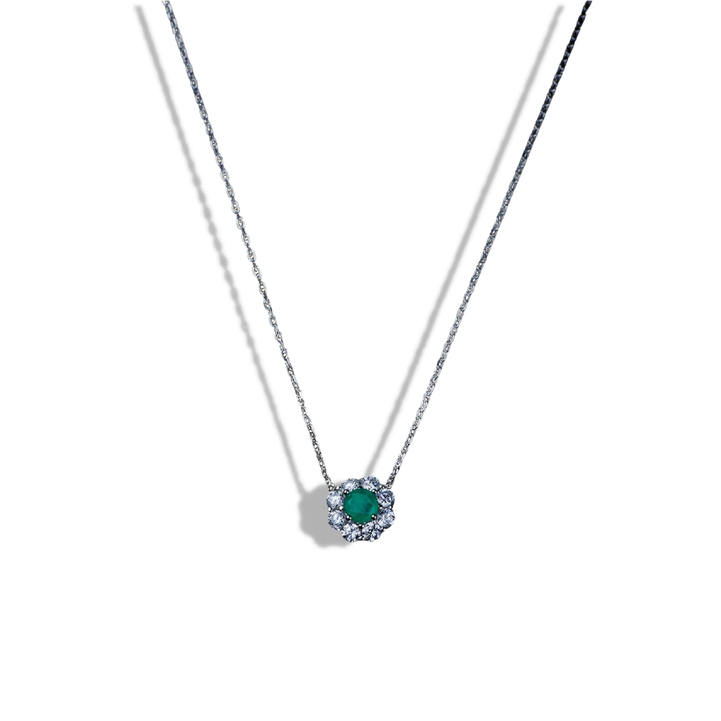 Necklace with a green gemstone pendant on a white background