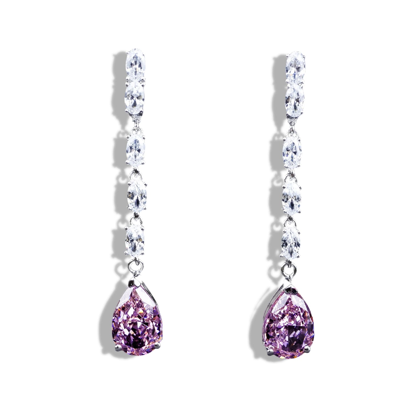 Pair of earrings with purple teardrop stones on a white background