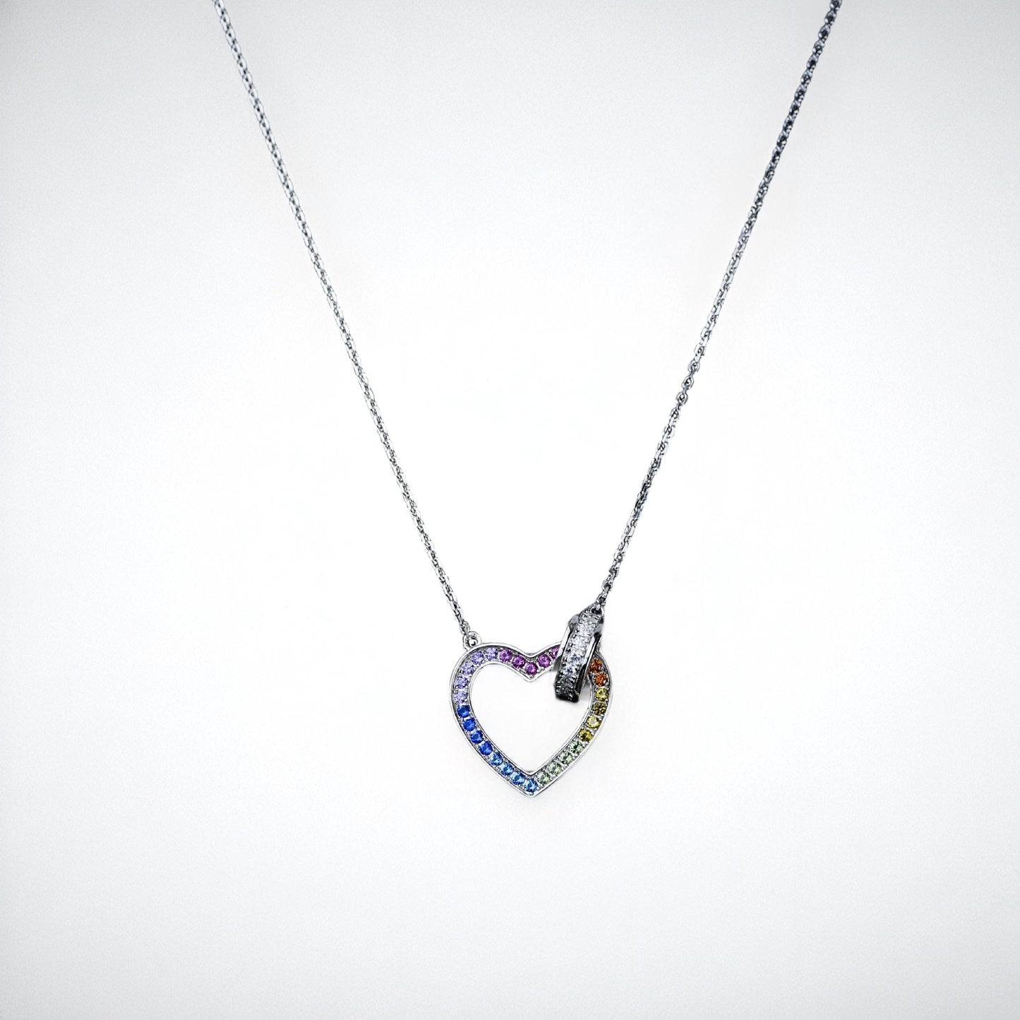 Heart-shaped necklace with colorful stones on a white background