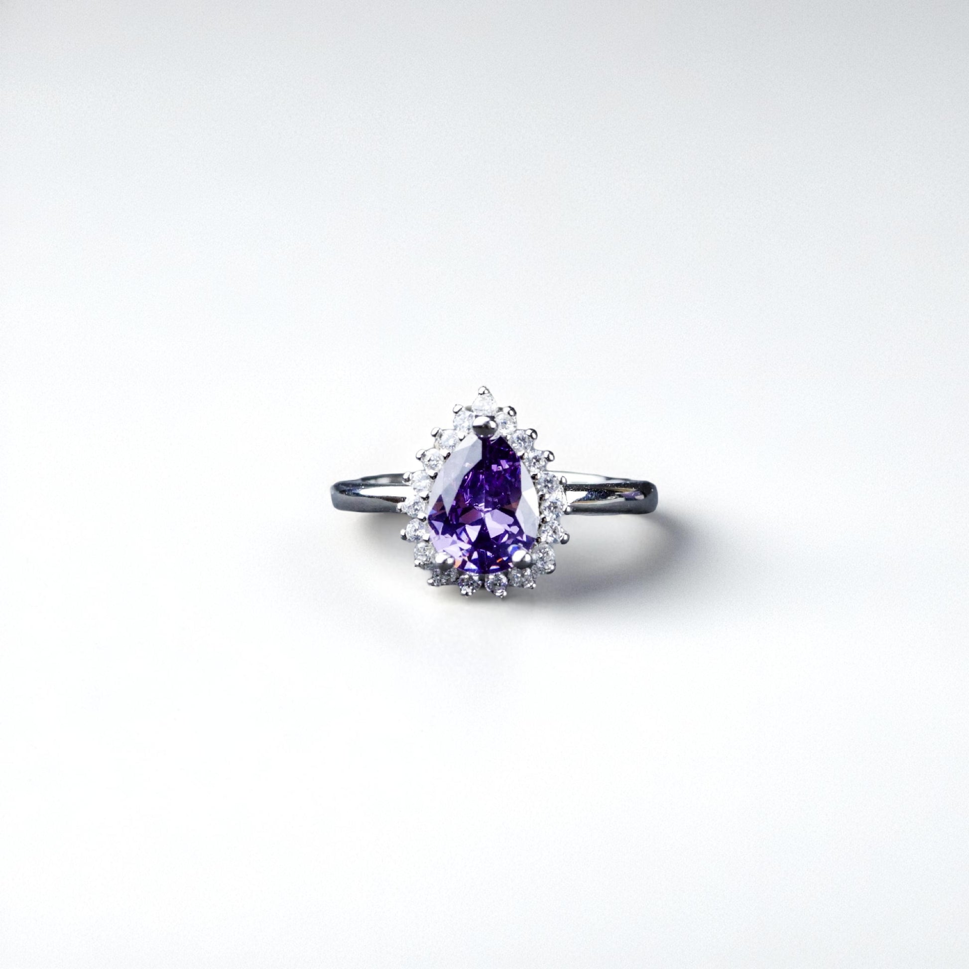 Ring with a purple gemstone on a white background