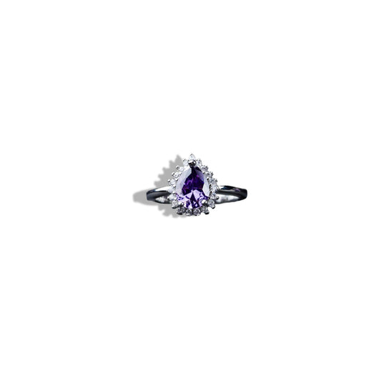 Ring with a purple gemstone on a white background