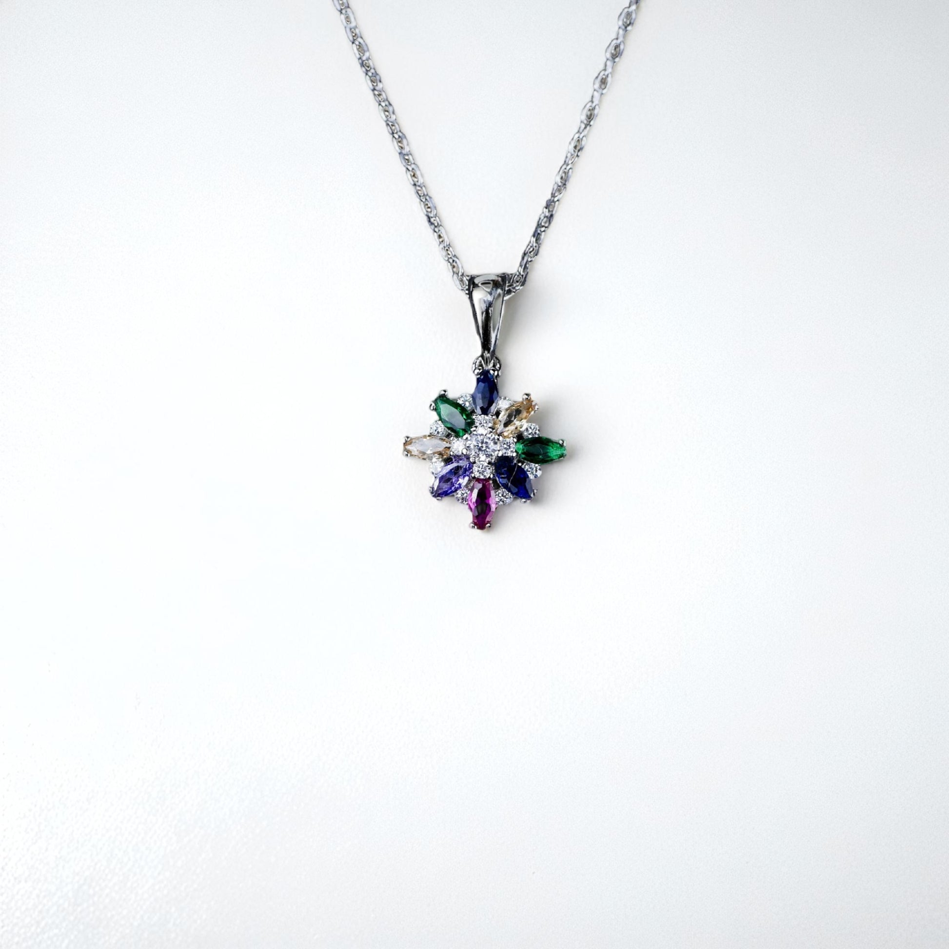 Multicolored gemstone pendant on a white background
