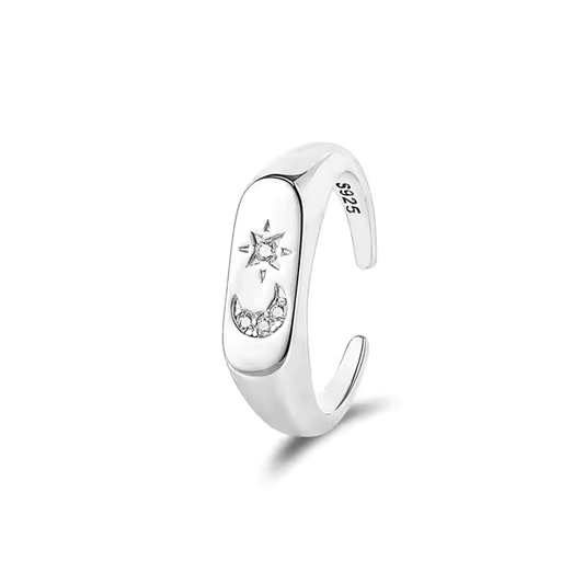 An adjustable sterling silver ring with a cubic zirconia stone, featuring a rhodium plating and an open band design with a crescent moon and stars motif.