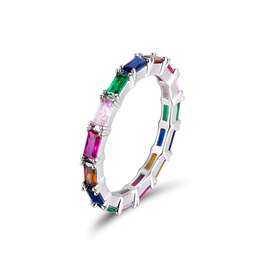 A petite ring with a color gradient design, featuring multiple colored gemstones set in a silver band with rhodium plating.