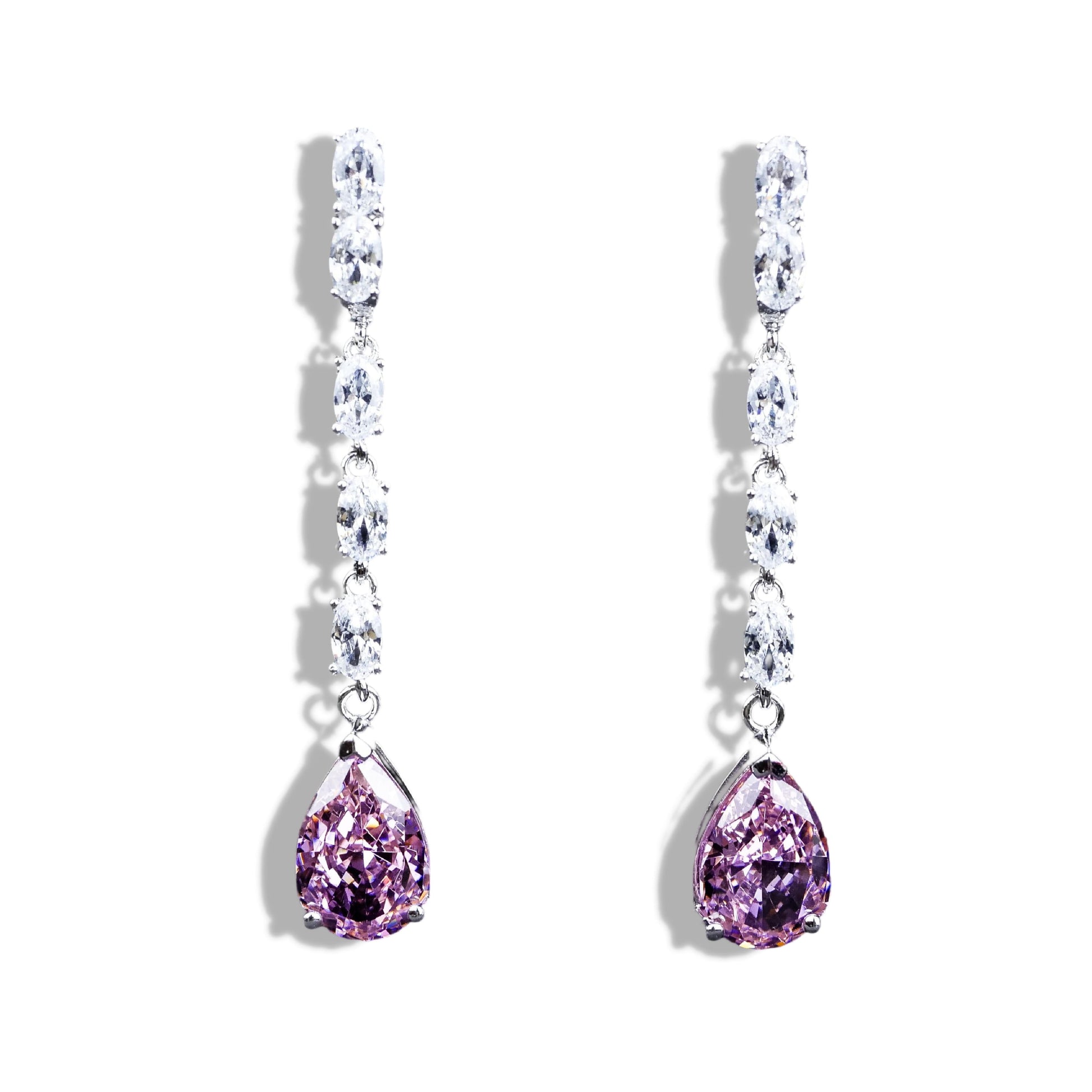 Pair of earrings with purple teardrop stones on a white background