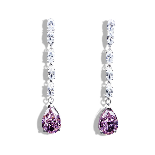 Pair of earrings with purple teardrop stones on a white background
